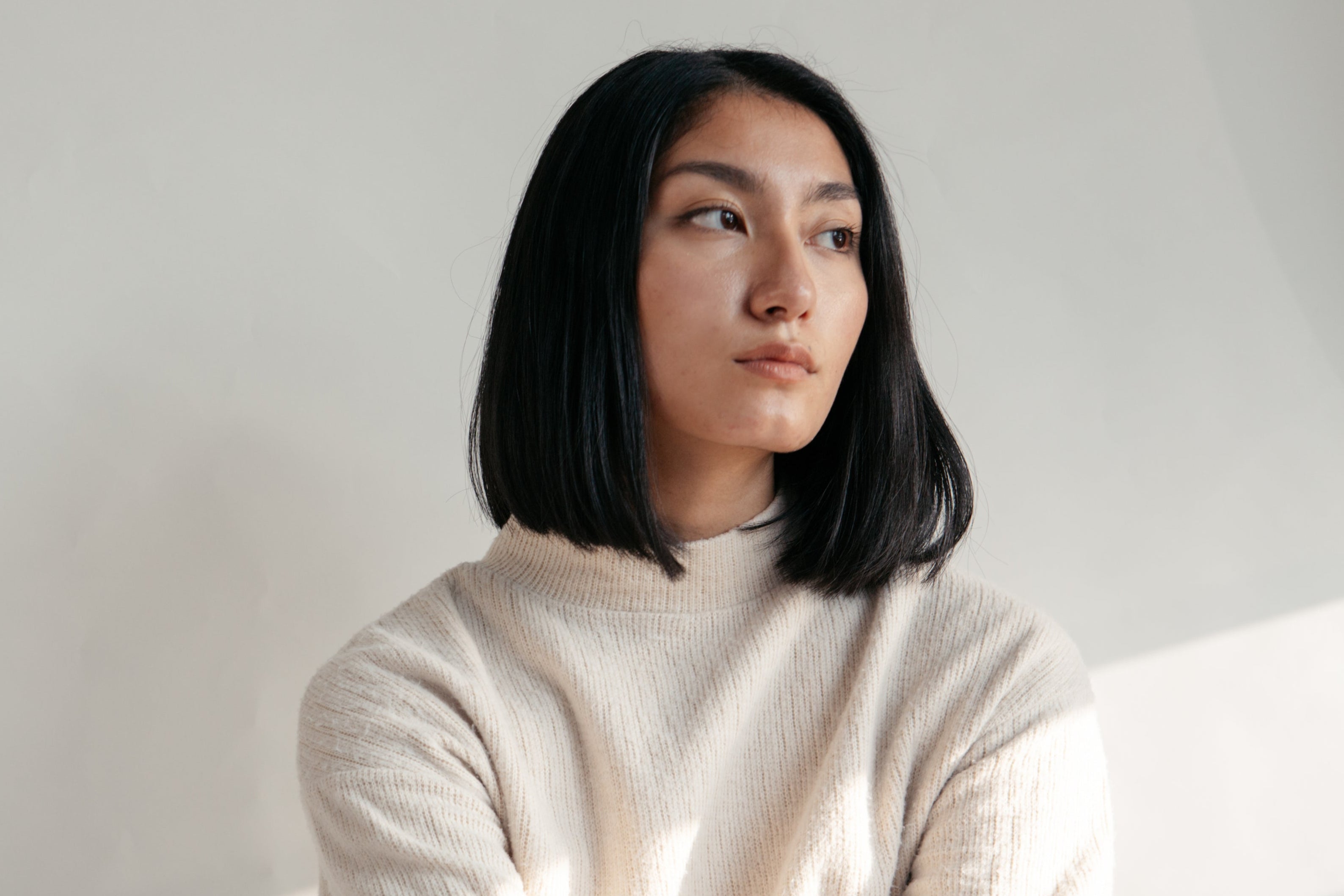 model-in-neutral-colors-by-window.jpg